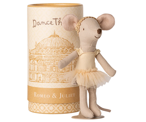 Stuffed mouse doll in a tutu dress next to a cylindrical box with decorative design and text.