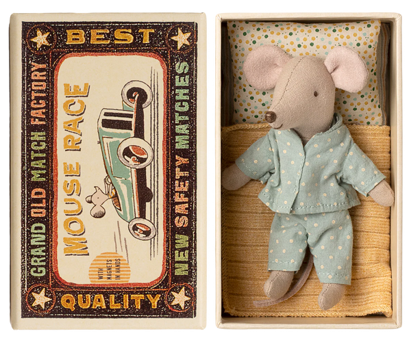 Toy mouse in blue pyjamas in a matchbox on a white background