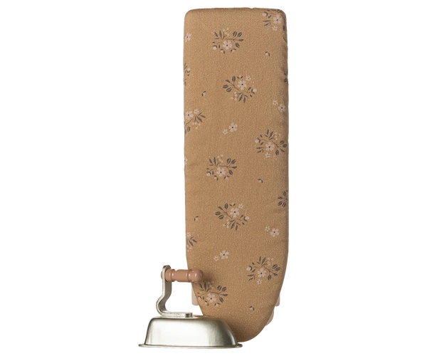 Floral-patterned ironing board cover with metal base on a white background