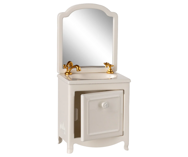 Bathroom vanity with mirror and gold fixtures on a white background