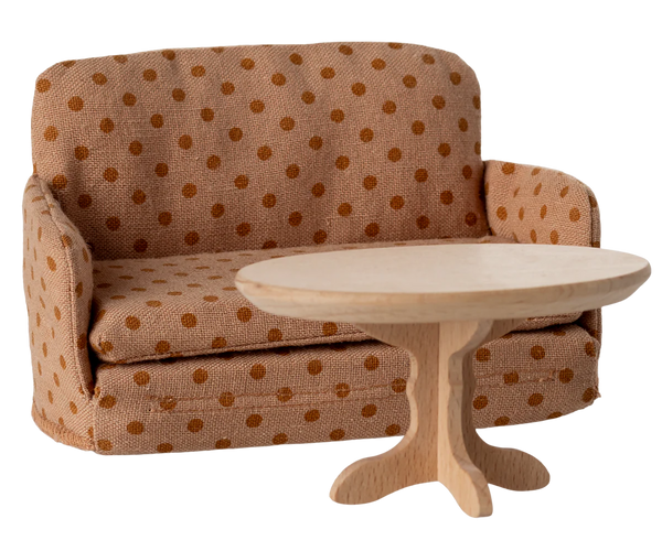 Polka dot sofa with a matching side table on a white background