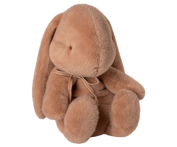 Pink plush soft toy bunny on a white background