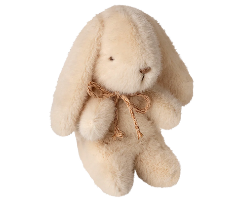 Cream plush bunny with a brown bow on a white background
