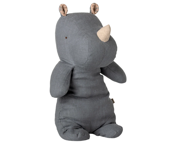 A blue grey coloured plush rhino toy sitting against a white background.