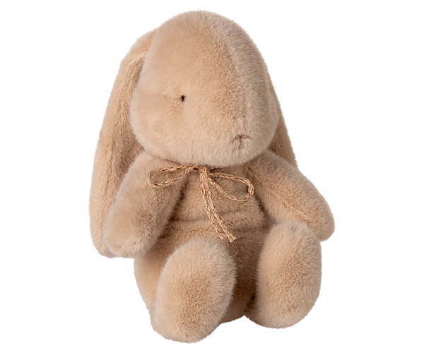 Plush bunny toy with a bow on a white background