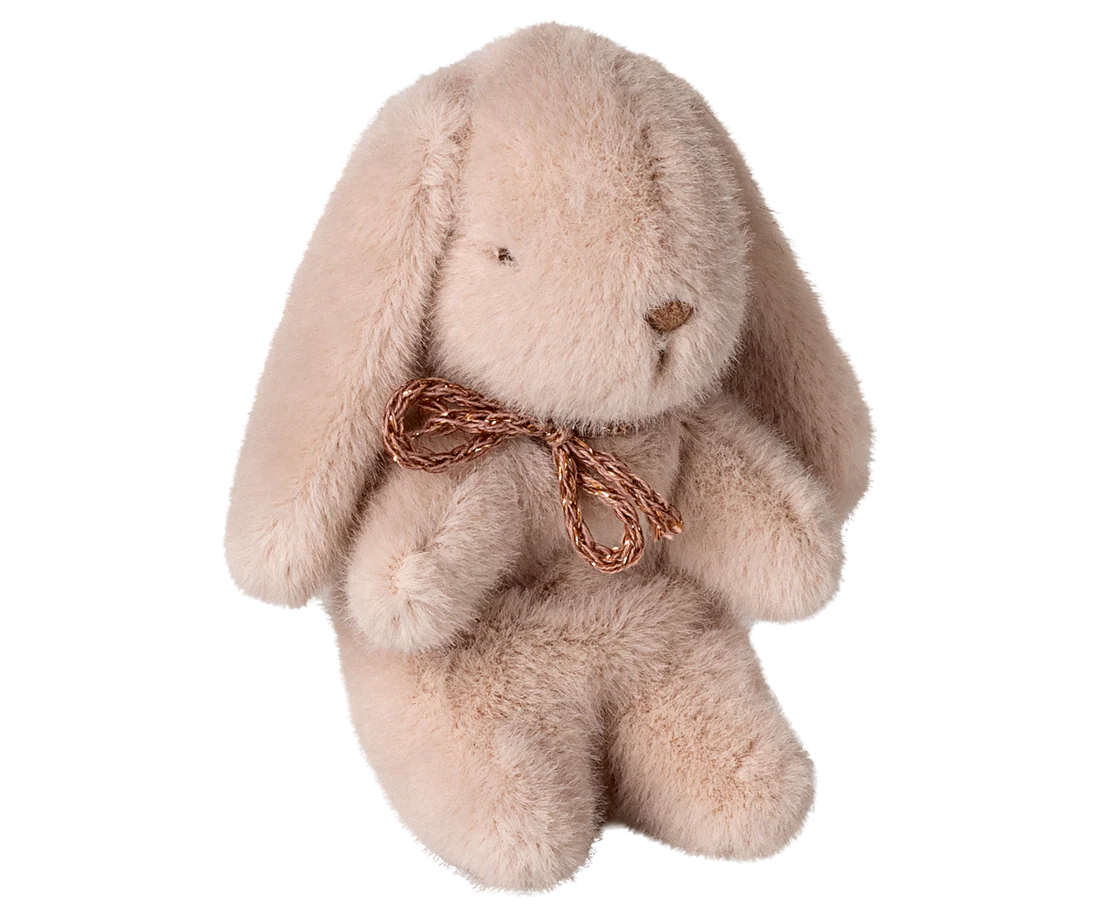 Plush pink bunny toy with a brown bow on a white background