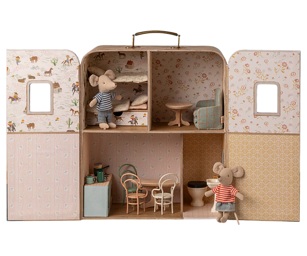 Miniature dollhouse with furniture and toy mice inside a suitcase