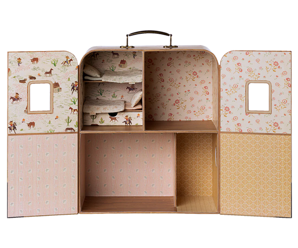 Children's playhouse with patterned doors on a white background
