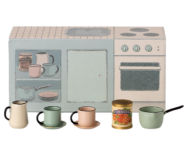 Children's play kitchen set with toy stove, oven, and various kitchen items on a white background.