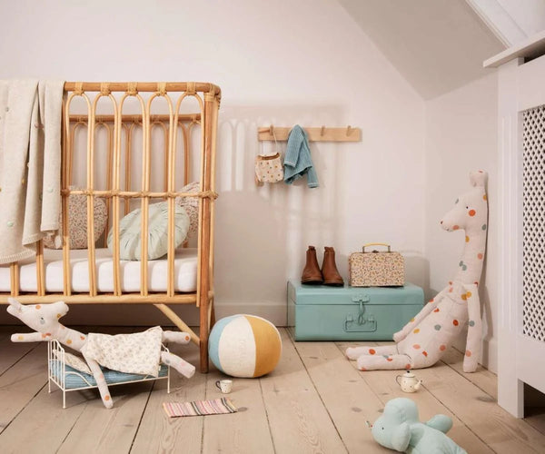 Nursery room with wooden crib, toys, and storage boxes.