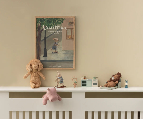 Children's room with toys on a radiator shelf and a framed picture on the wall.