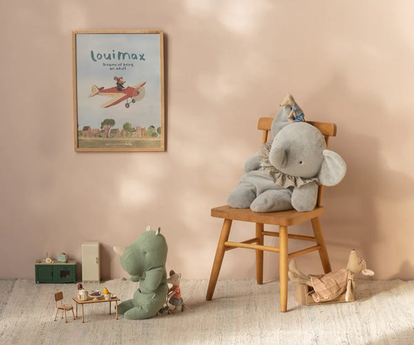 Children's room with plush toys and a framed picture on the wall.