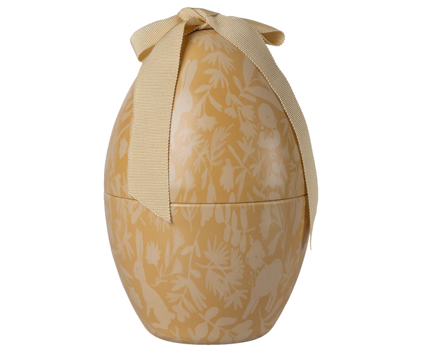 Decorative egg-shaped metal tin with floral pattern and ribbon on a white background