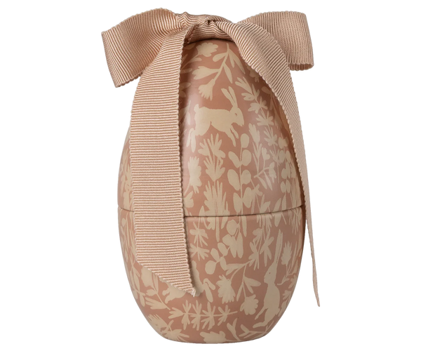 Decorative Easter egg tin with floral patterns and a bow on a white background