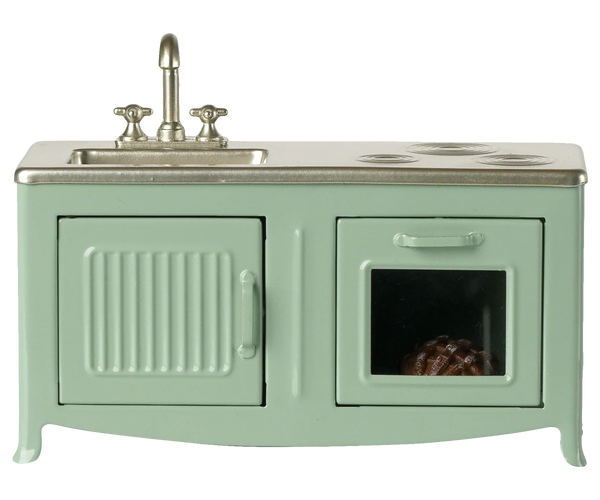 Mint green toy kitchen with sink and stove on a white background
