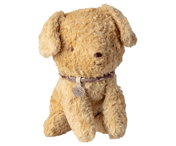 Beige stuffed dog toy with a collar on a white background