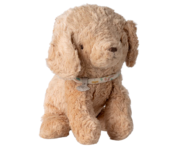 Beige stuffed dog toy with a collar on a white background