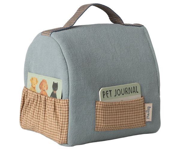 Blue pet travel bag with pockets and 'Pet Journal' card on a white background