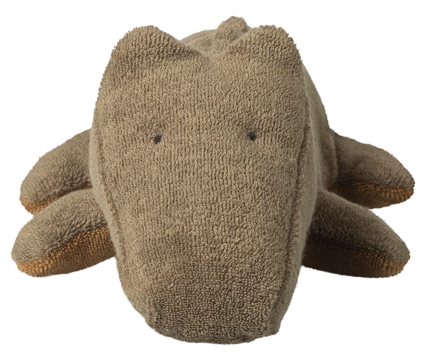 Light green plush toy crocodile on a white background