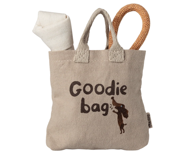 Beige goodie bag with text and a small animal illustration on a white background