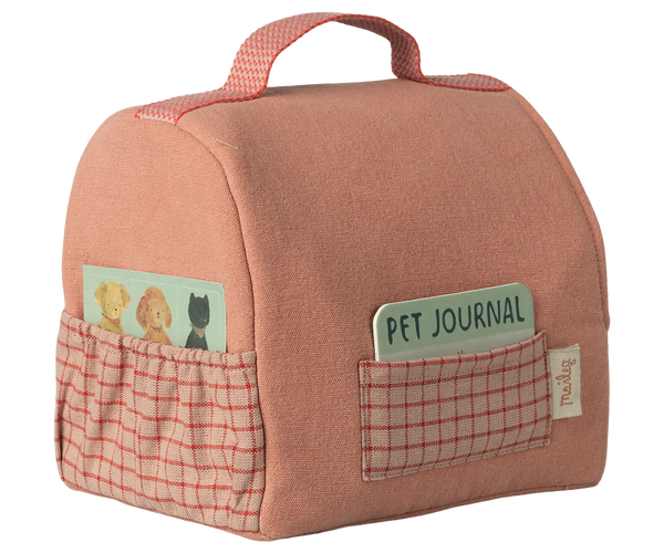 Pink pet travel bag with pockets and 'Pet Journal' label on a white background