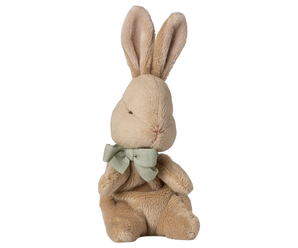 Plush rabbit toy with a green bow tie on a white background