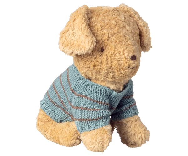 Stuffed dog wearing a blue striped sweater on a white background