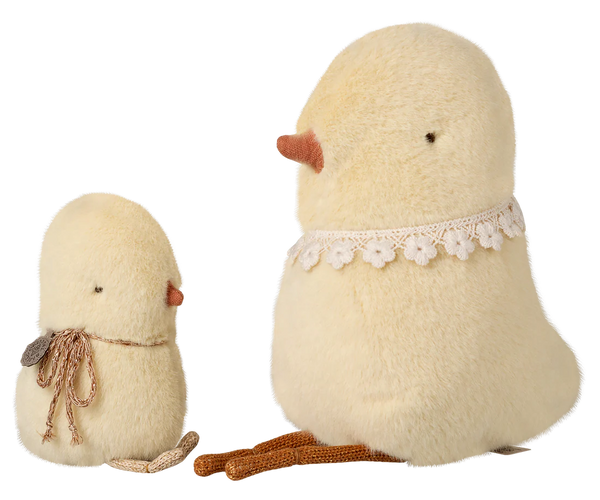 Two fluffy toy chicks with lace details on a white background