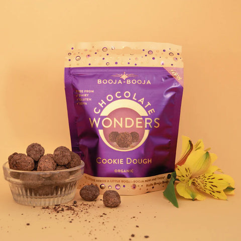 Booja-Booja Chocolate Wonders Cookie Dough packaging with truffles and a flower on a beige background
