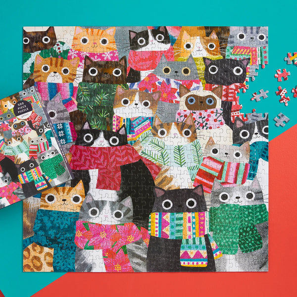 Jigsaw puzzle with colourful cat-themed pieces on a blue and orange background