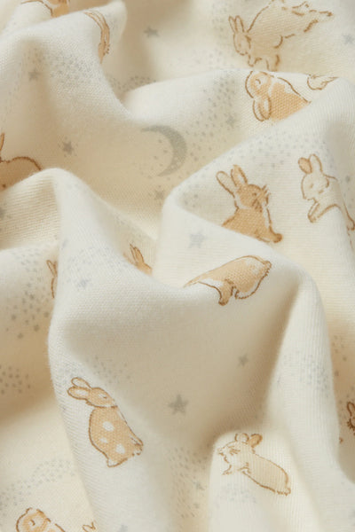 Fabric with small bunny, moon and star prints on a white background