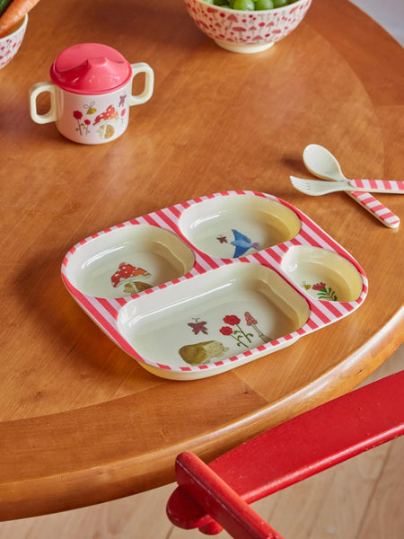 Children's tableware set including a tray, cup, and spoon on a wooden table.