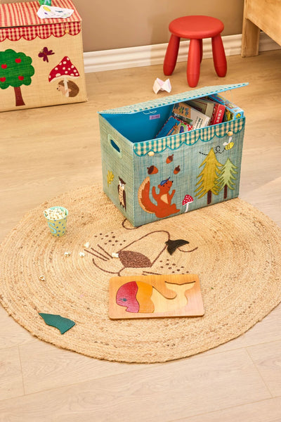 Toy storage box with children's items on a wooden floor