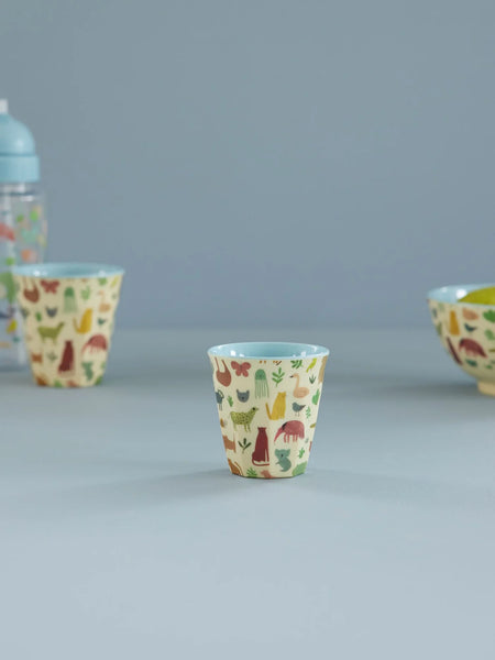 Set of children's cups with animal pattern on a blue background