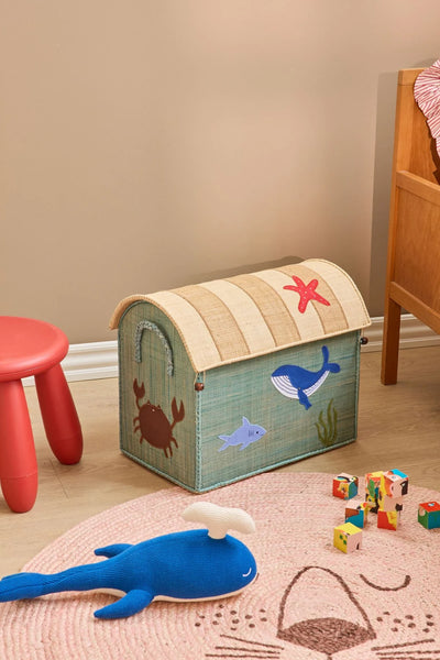 Blue whale toy on a rug in a child's bedroom