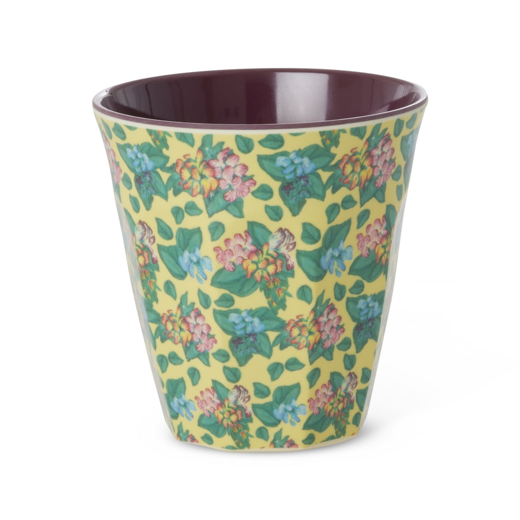 Floral print yellow cup against a white background