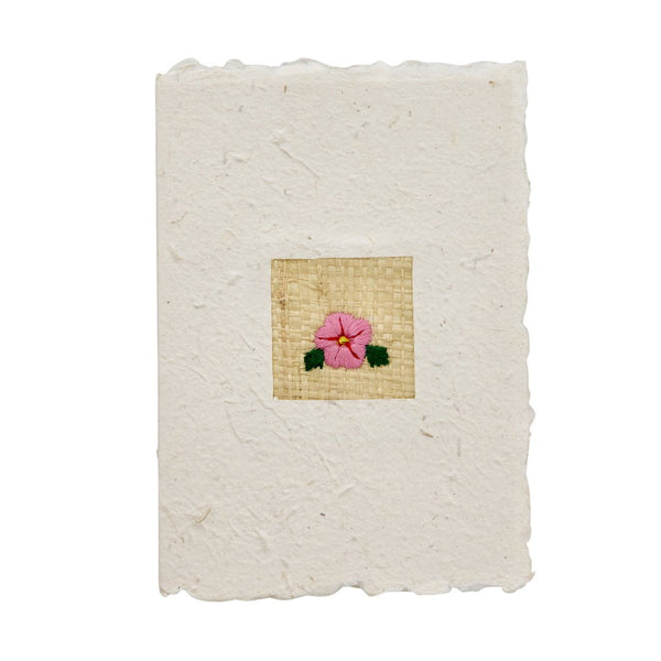 Handmade greeting card with a woven flower design on a white background