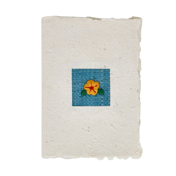 Handmade greeting card with a woven flower design on a white background