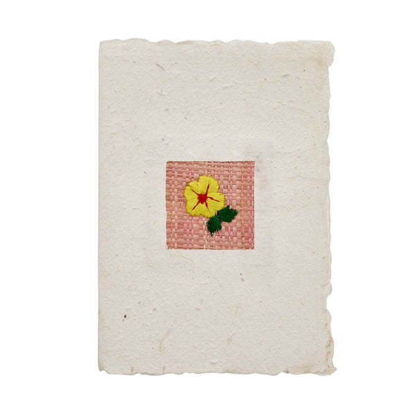 Handmade greeting card with a woven flower design on a white background