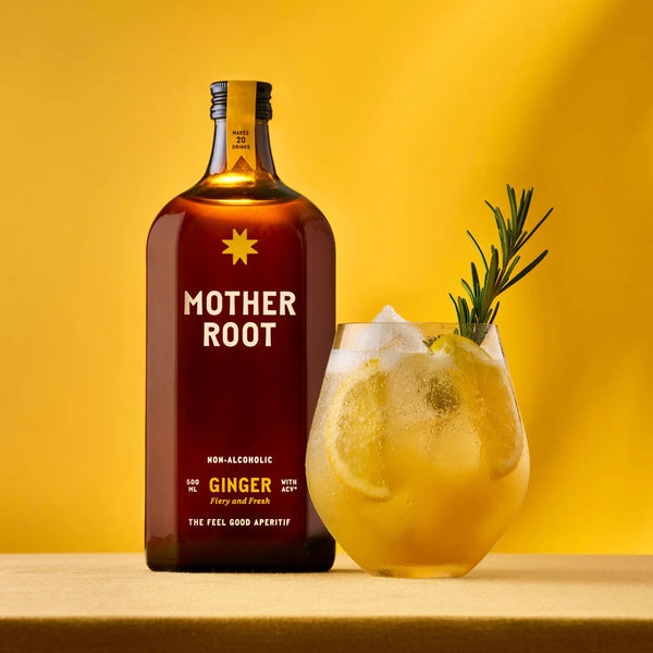 Bottle of Mother Root ginger drink with a non-alcoholic ginger beverage on a yellow background