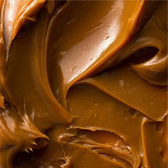 Close-up of creamy peanut butter with a rich brown color.
