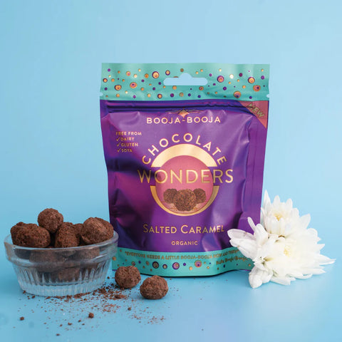 Purple package of Booja-Booja Chocolate Wonders Salted Caramel truffles on a blue background