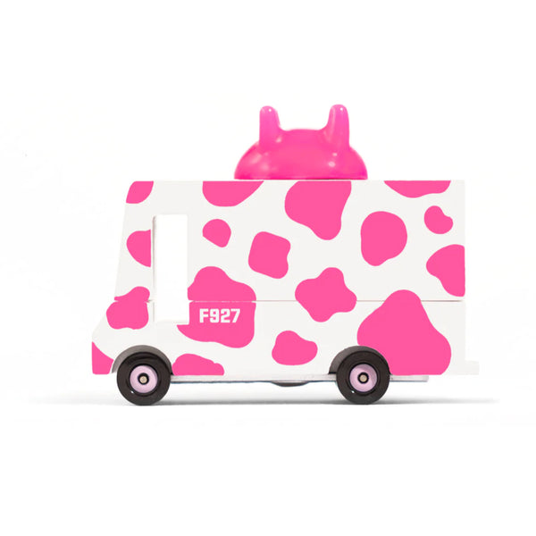 Toy truck with pink cow print design on a white background