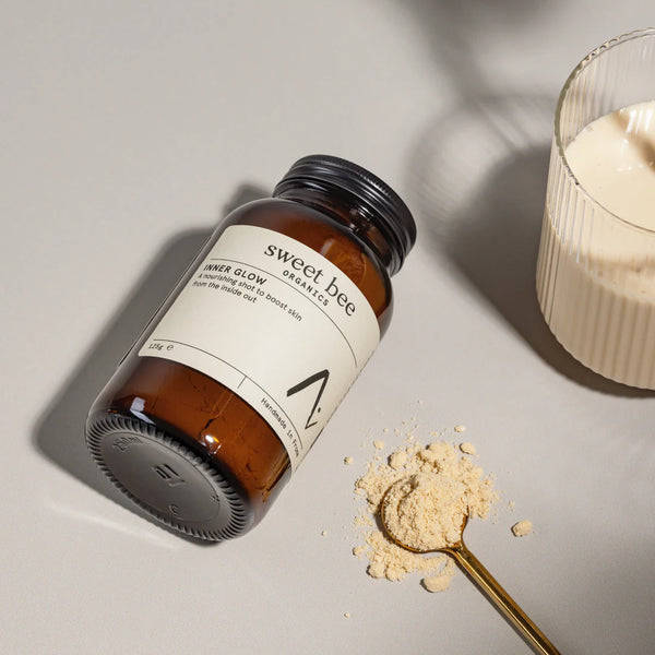 Sweet Bee organics Inner Glow  jar with powder on a light surface