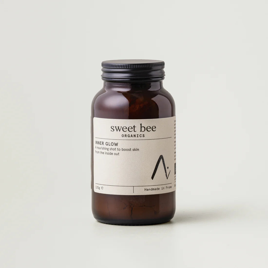 Brown jar with a Sweet Bee Organics label on a light gray background