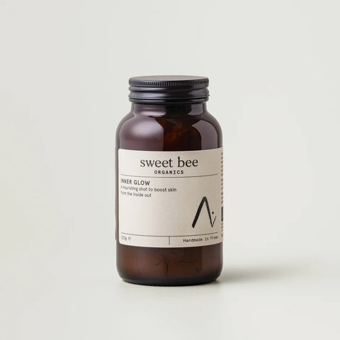 Brown jar with a Sweet Bee Organics label on a light gray background