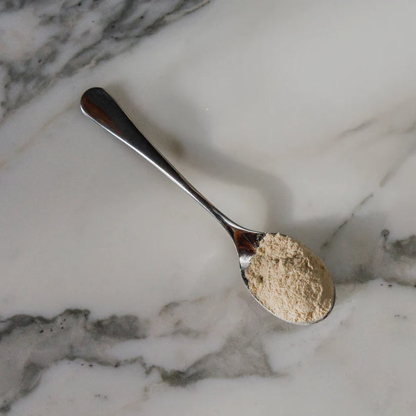 Spoonful of powder on a marble surface