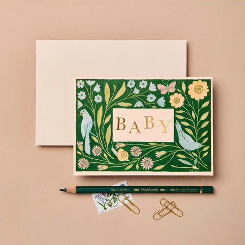 Decorative baby card with floral design and gold 'BABY' text on a beige background