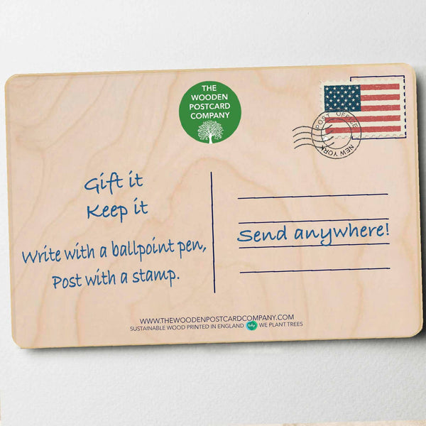 Wooden postcard with text and branding on a light gray background