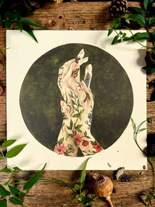 Illustration of tattooed hands with flowers and butterflies on a wooden surface with leaves.